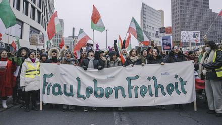 Menschen protestieren am Potsdamer Platz in Berlin gegen das Mullah-Regime.