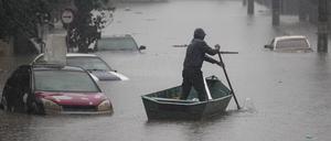 Ein Mann rudert mit einem Boot auf einer durch starke Regenfälle überfluteten Straße im brasilianischen Bundesstaat Rio Grande do Sul.