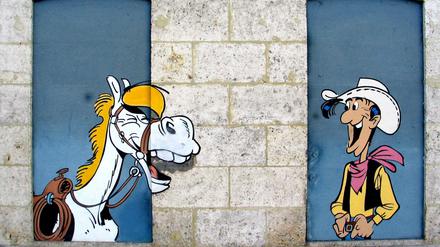 Erfolgsteam. Seit mehr als 70 Jahren reiten Lucky Luke und Jolly Jumper - hier ein Wandbild in Angouleme - durch den Wilden Westen.