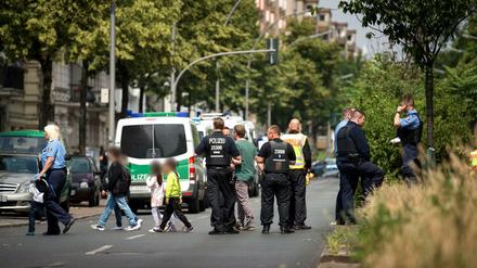 Polizisten führen Kinder einer Berliner Grundschule über die Straße.